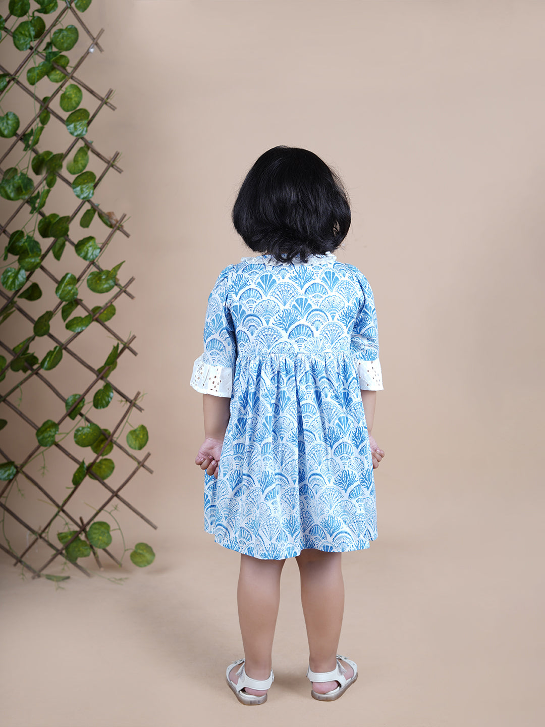 Girl wearing Sea Shells printed blue frock