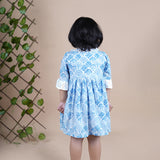 Girl wearing Sea Shells printed blue frock