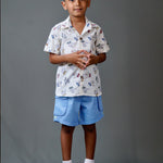 Boy wearing cotton white shirt with Dino print and Blue shorts