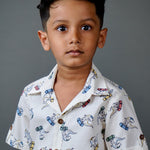 Boy wearing cotton white shirt with Dino print and Blue shorts