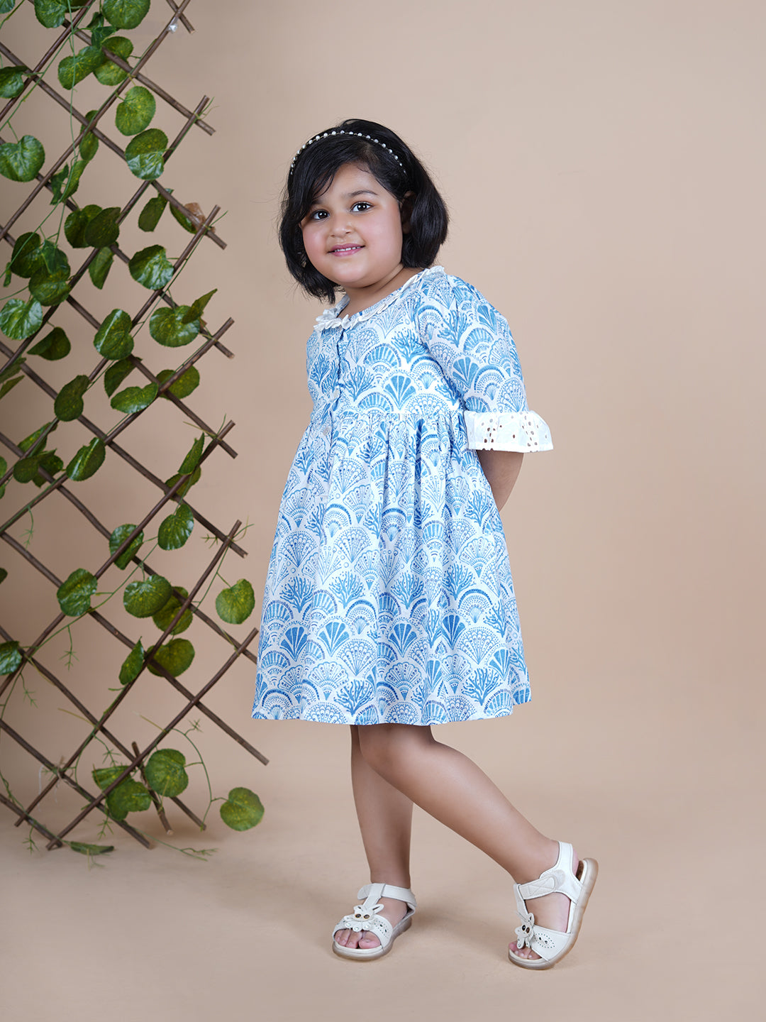 Girl wearing Sea Shells printed blue frock