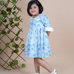 Girl wearing Sea Shells printed blue frock