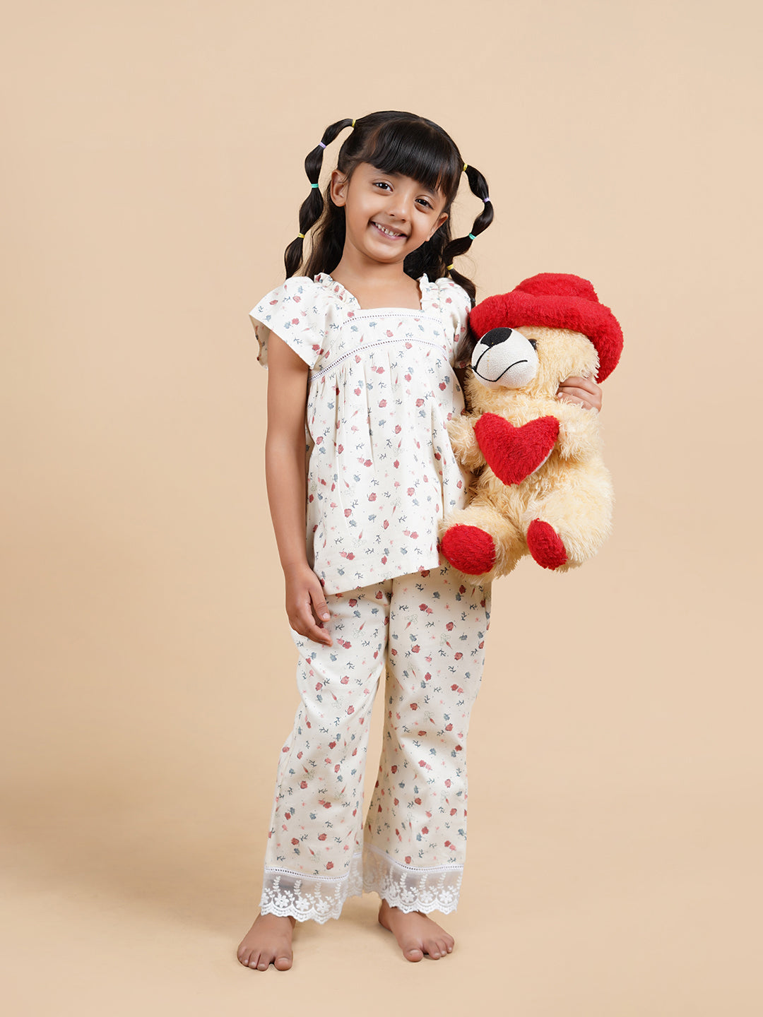 Girl wearing floral printed cotton lounge wear and holding a teddy bear