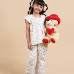 Girl wearing floral printed cotton lounge wear and holding a teddy bear