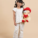 Girl wearing floral printed cotton lounge wear and holding a teddy bear