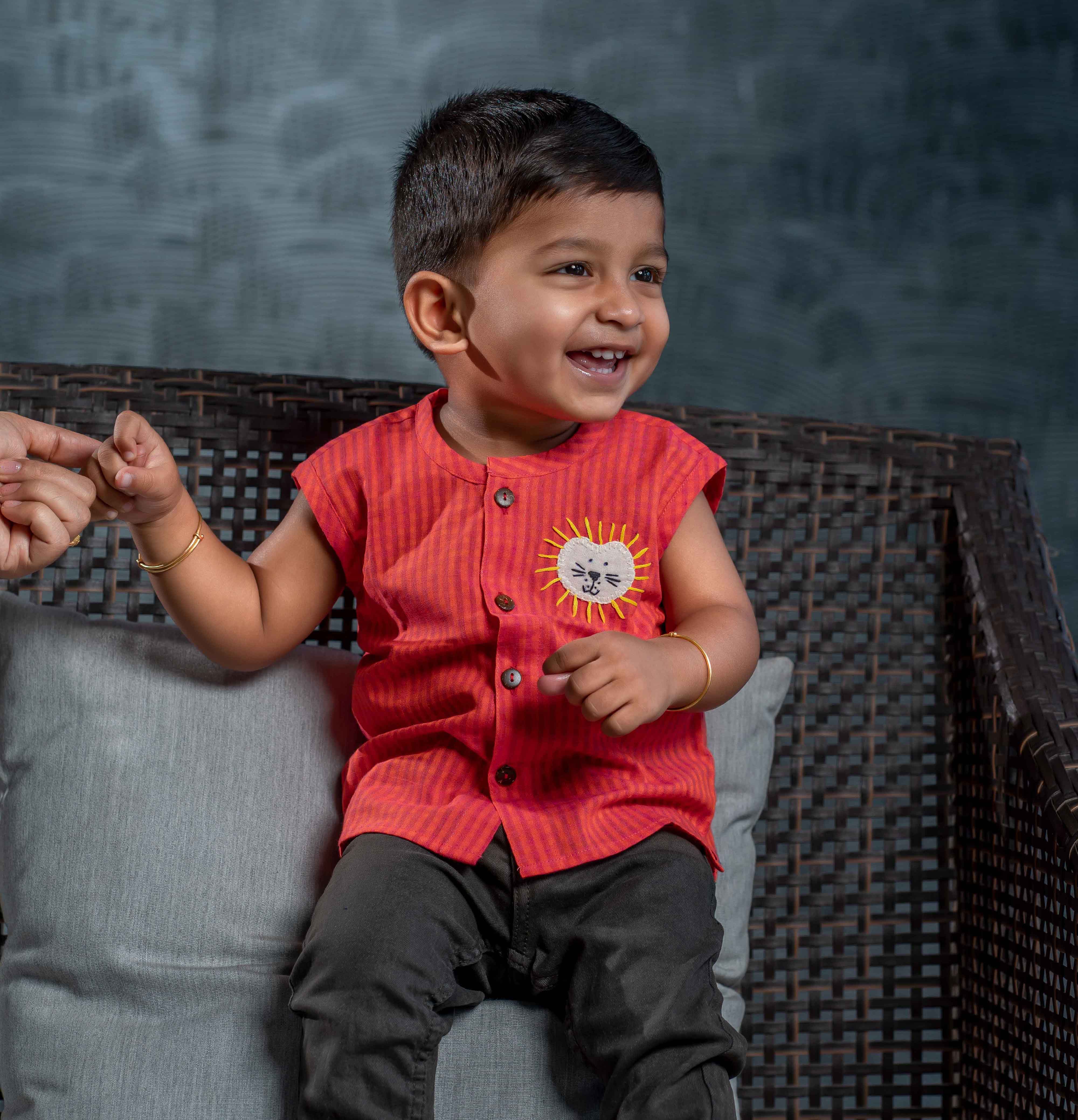 Smiling baby boy wearing cotton jabla with embroidery