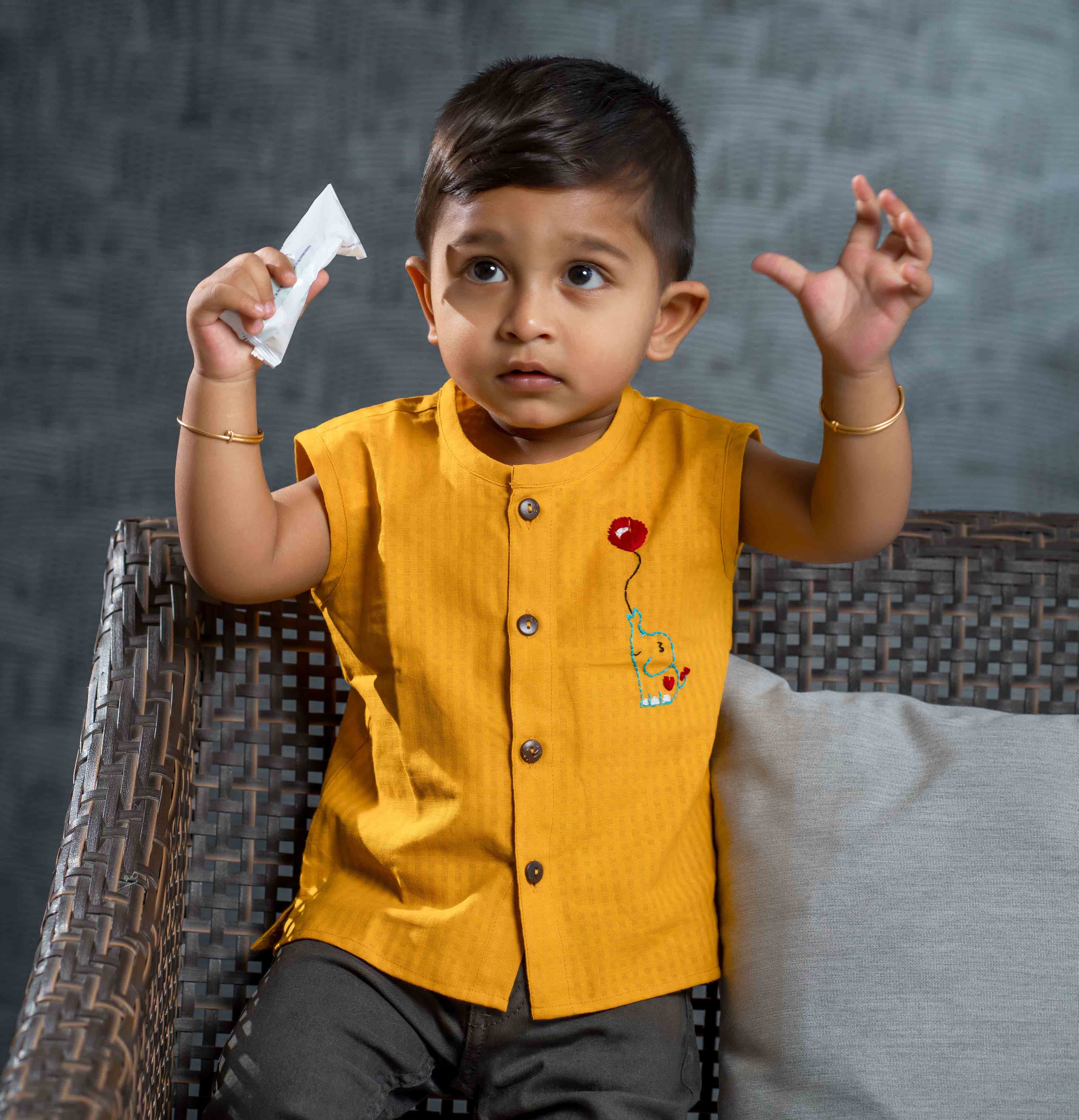 Smiling baby boy wearing cotton jabla with embroidery