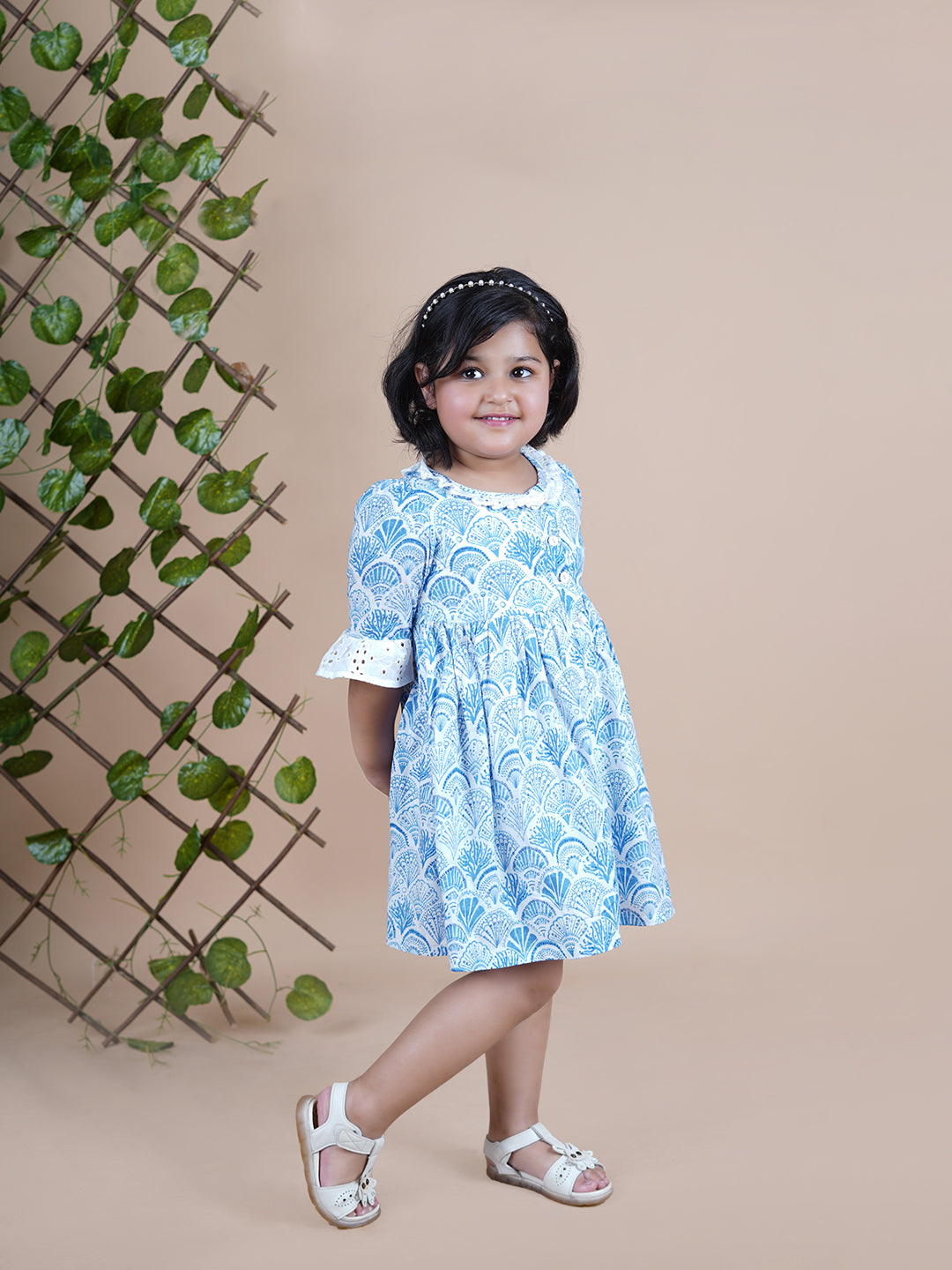 Girl wearing Sea Shells printed blue frock