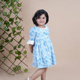 Girl wearing Sea Shells printed blue frock