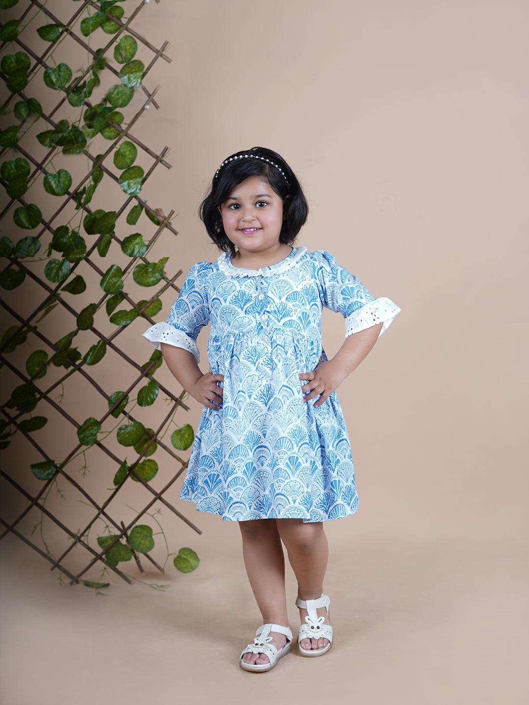 Girl wearing Sea Shells printed blue frock