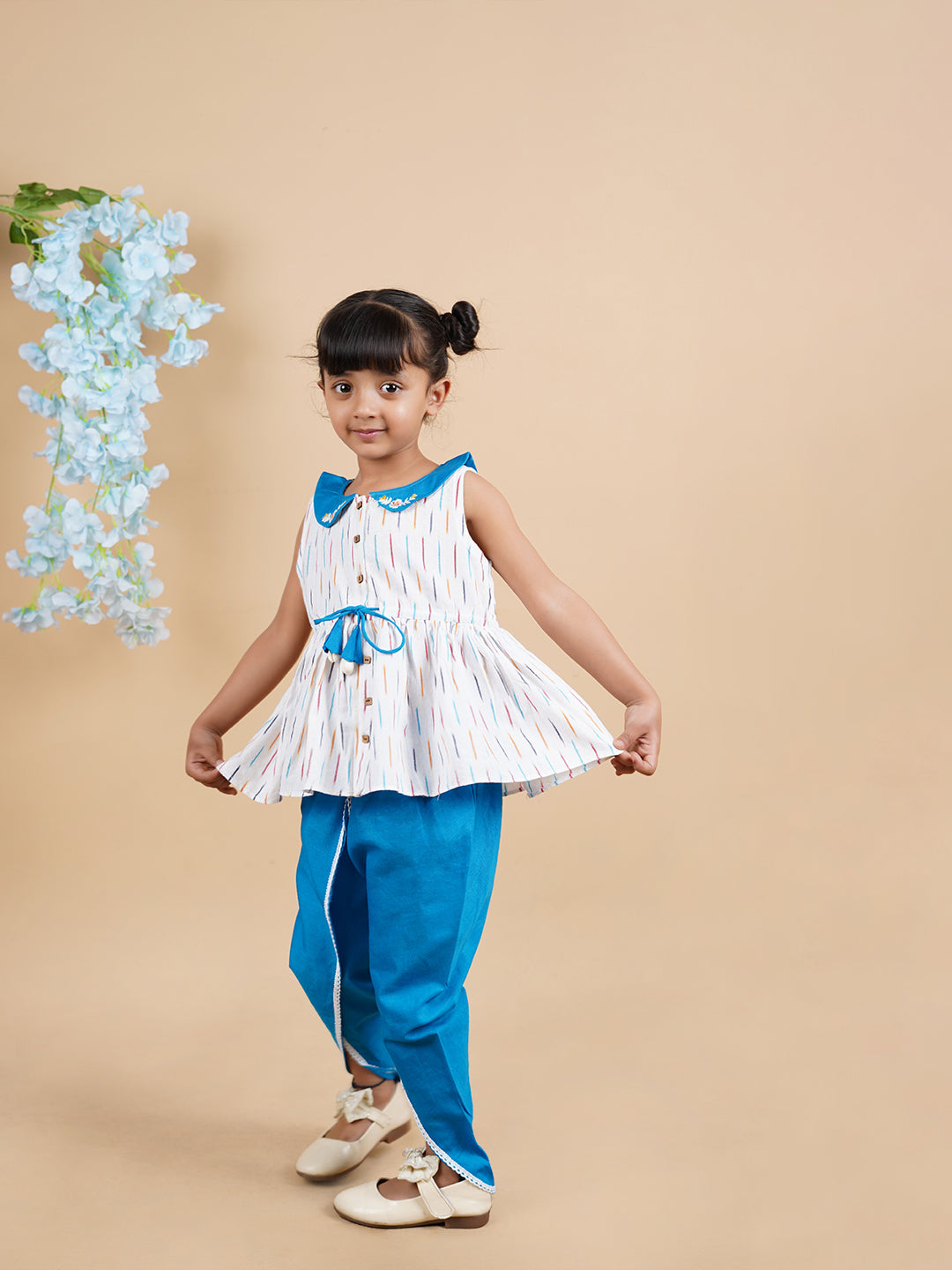 A girl wearing Blue Ikkat Cotton Kurta and Dhoti Pant