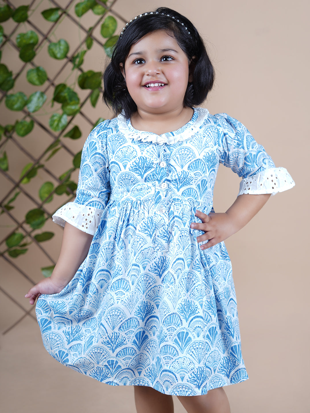 Girl wearing Sea Shells printed blue frock