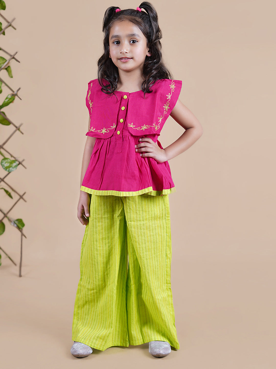 Girl wearing Red top with embroidery and lime green palazzo pants