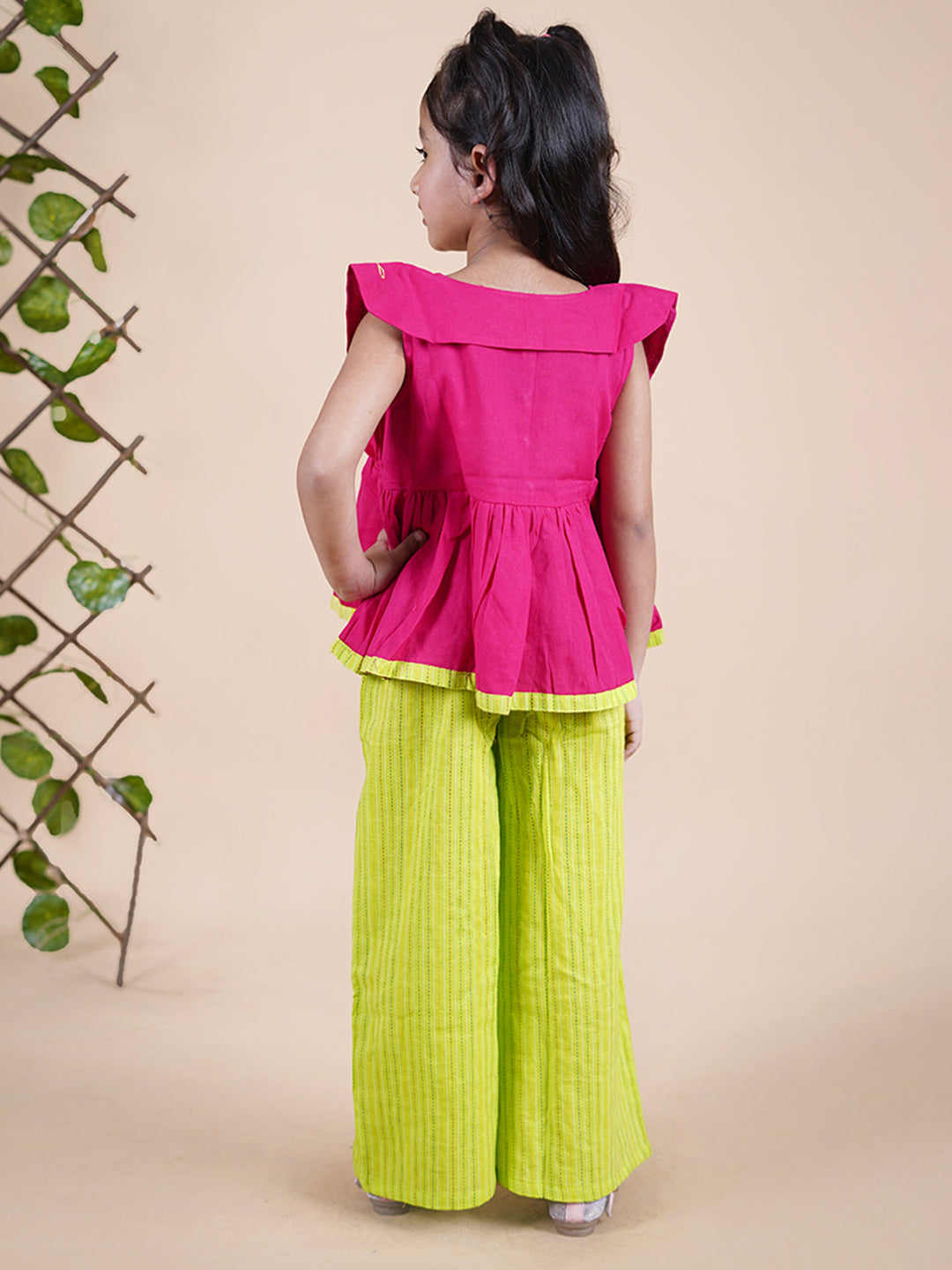 Girl wearing Red top with embroidery and lime green palazzo pants