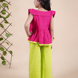 Girl wearing Red top with embroidery and lime green palazzo pants