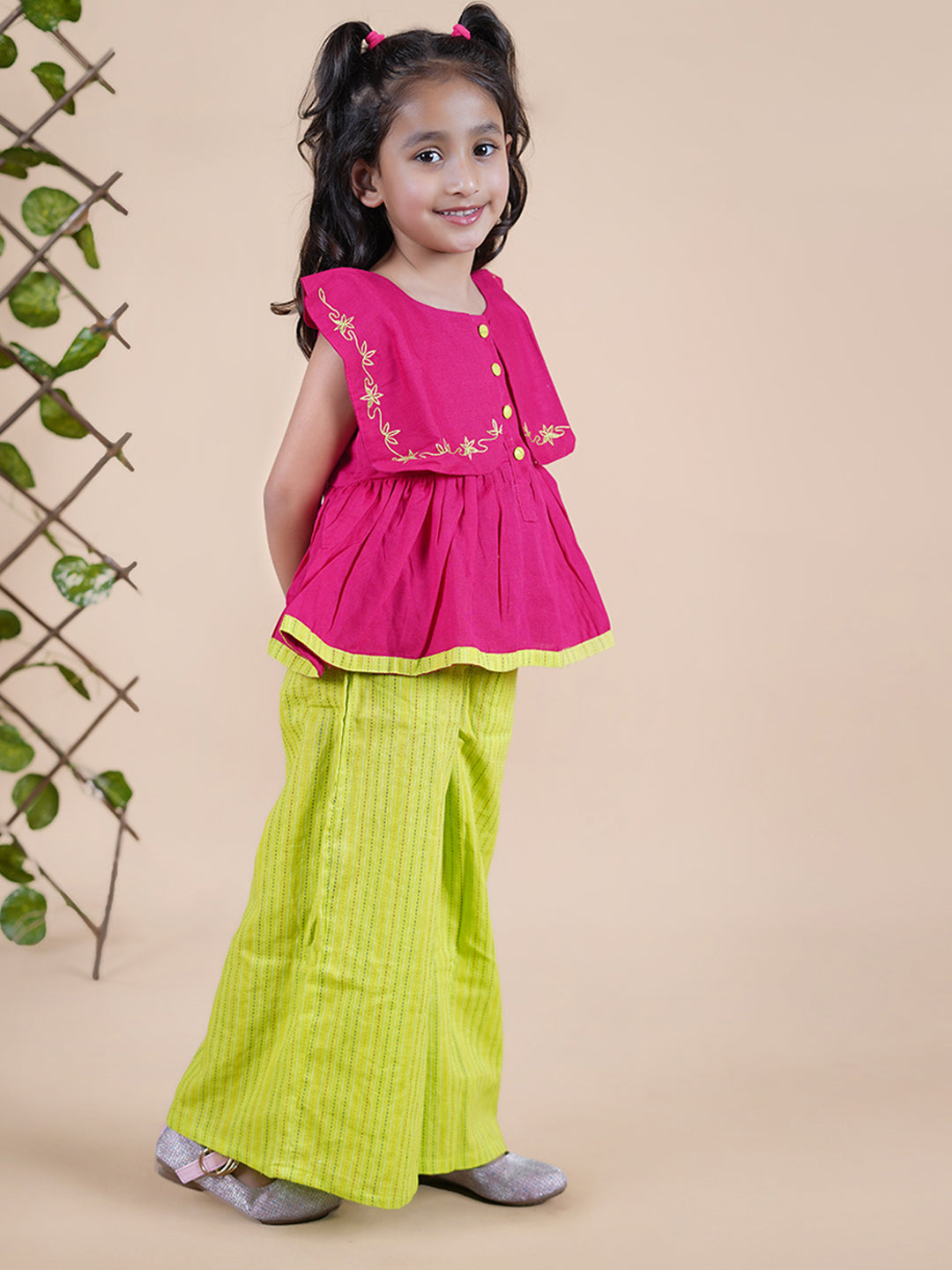 Girl wearing Red top with embroidery and lime green palazzo pants