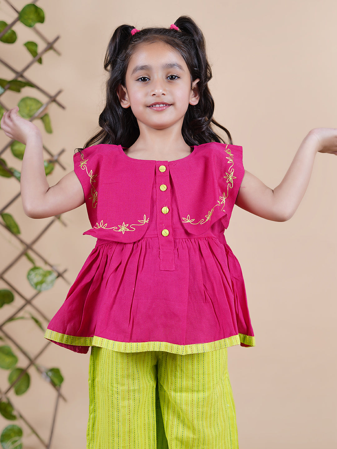 Girl wearing Red top with embroidery and lime green palazzo pants