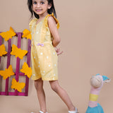 Girl wearing Yellow Jumpsuit with white dots and pink bows