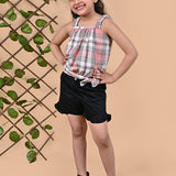 A girl wearing Checks top with straps and black shorts