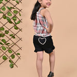 A girl wearing Checks top with straps and black shorts