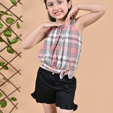 A girl wearing Checks top with straps and black shorts