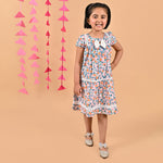 Girl wearing FLoral printed cotton frock that has a bow