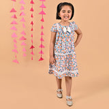 Girl wearing FLoral printed cotton frock that has a bow