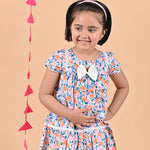 Girl wearing FLoral printed cotton frock that has a bow