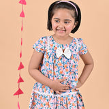 Girl wearing FLoral printed cotton frock that has a bow