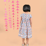 Girl wearing FLoral printed cotton frock that has a bow