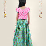 A girl wearing traditional attire in candy pink Cotton top and Green Block print skirt