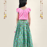 A girl wearing traditional attire in candy pink Cotton top and Green Block print skirt