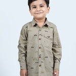 A boy wearing khaki cotton shirt with full sleeves and has cars printed on it