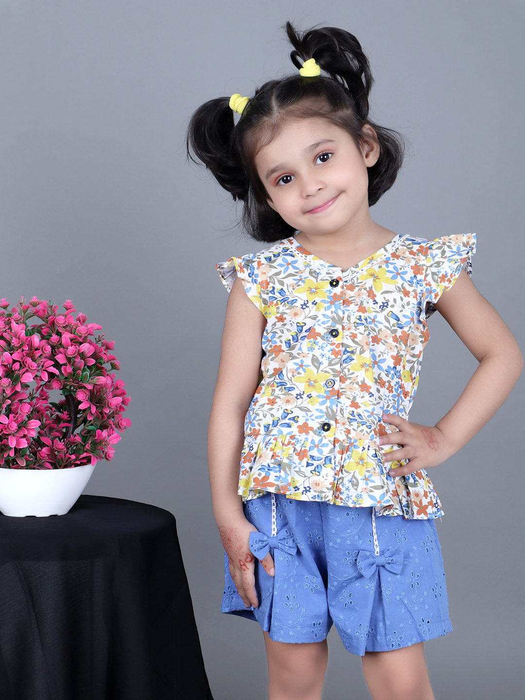 Girl wearing floral printed top and schiffli shorts