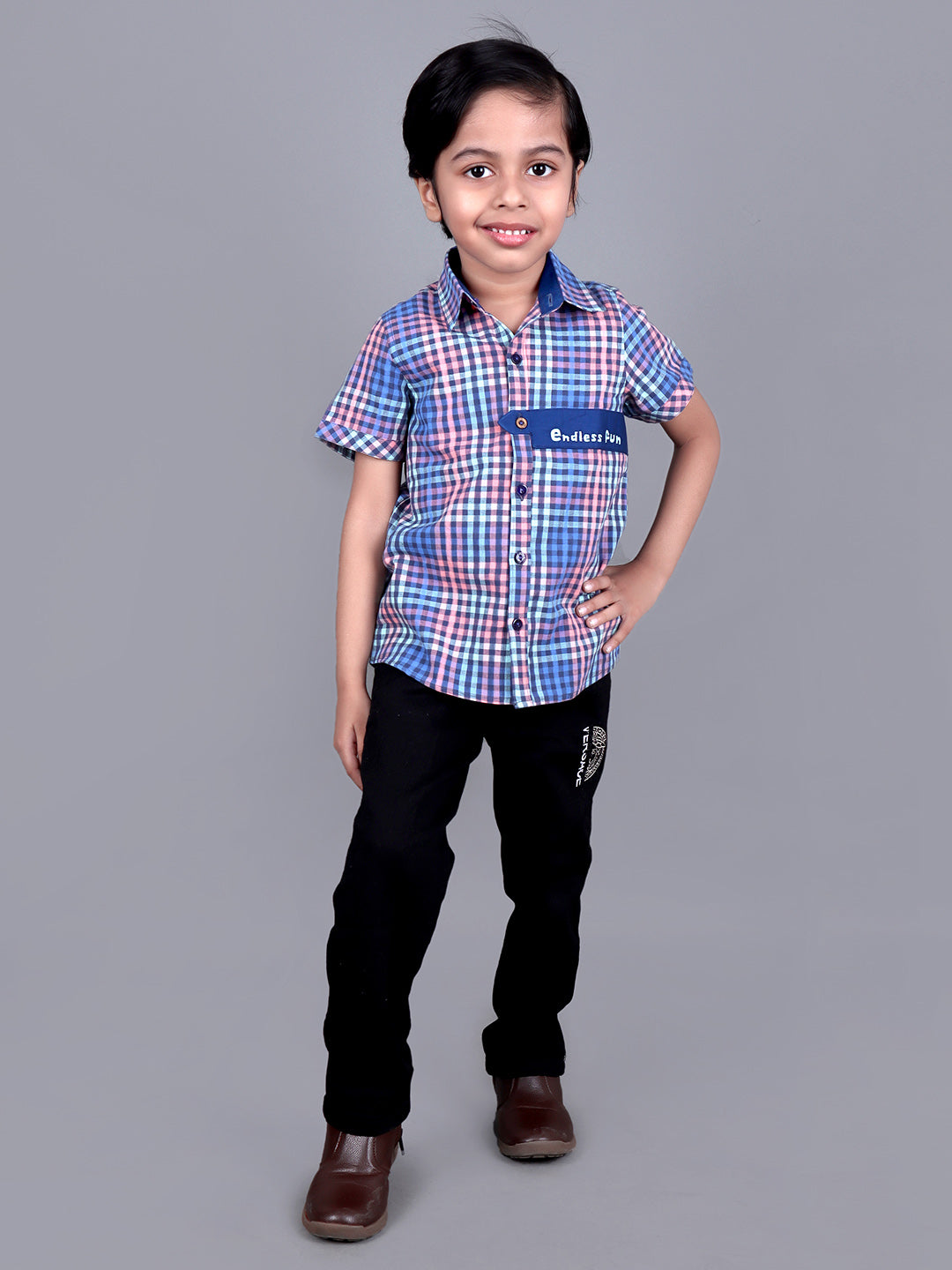 Boy wearing Blue Checks shirt with endless fun written on it