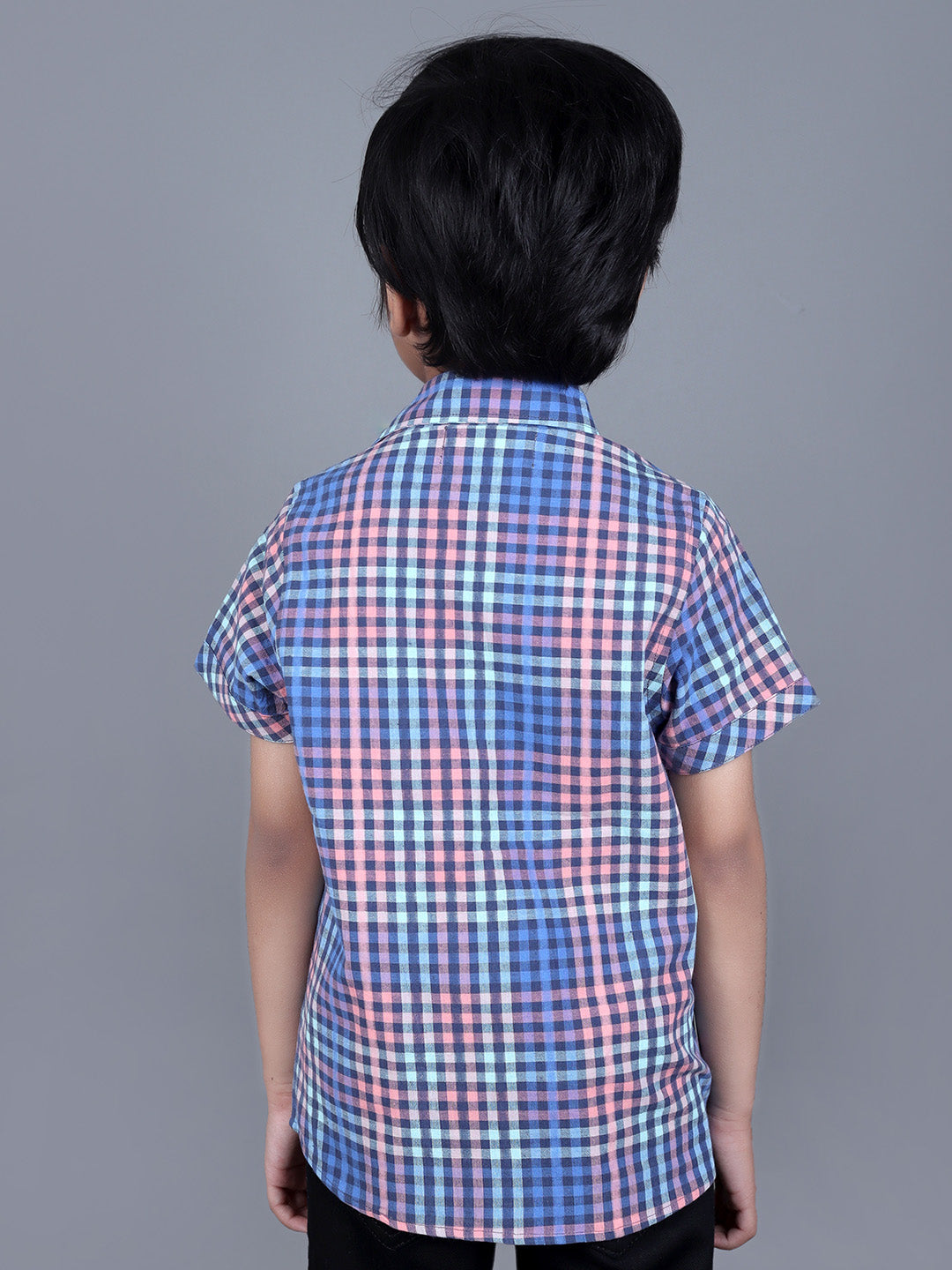 Boy wearing Blue Checks shirt with endless fun written on it