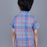 Boy wearing Blue Checks shirt with endless fun written on it