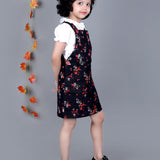 Smiling girl wearing Black floral Cotton Dungree with White Top inside