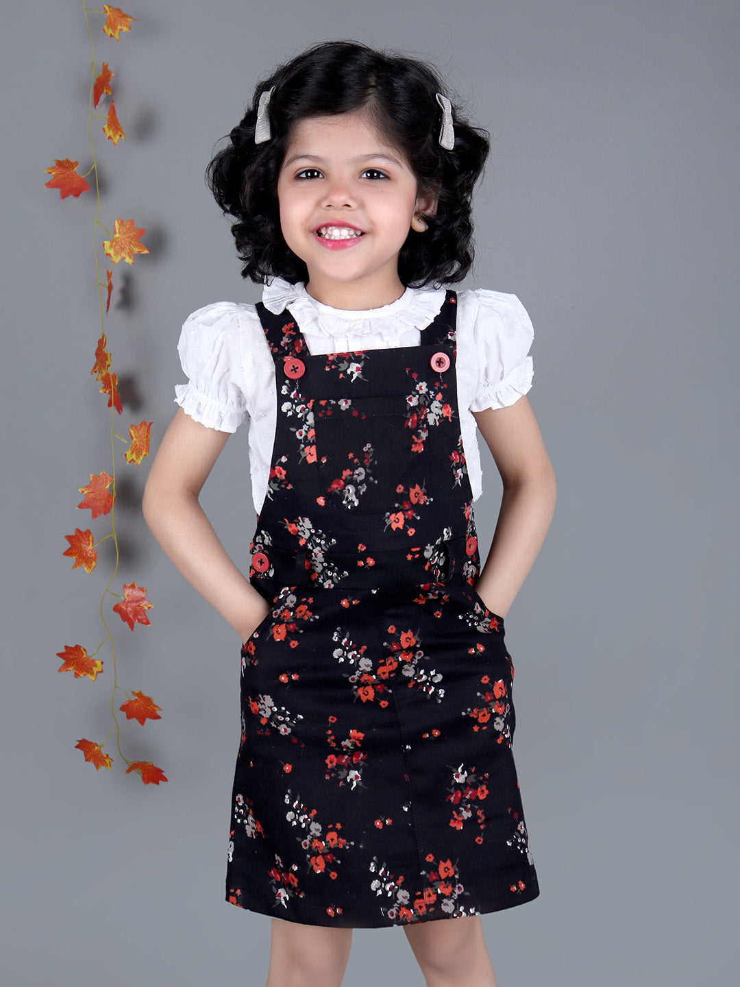 Smiling girl wearing Black floral Cotton Dungree with White Top inside