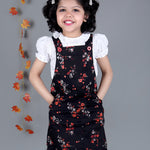 Smiling girl wearing Black floral Cotton Dungree with White Top inside