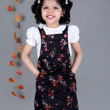 Smiling girl wearing Black floral Cotton Dungree with White Top inside