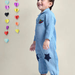 Smiling Baby Boy wearing blue cotton romper with stars on it