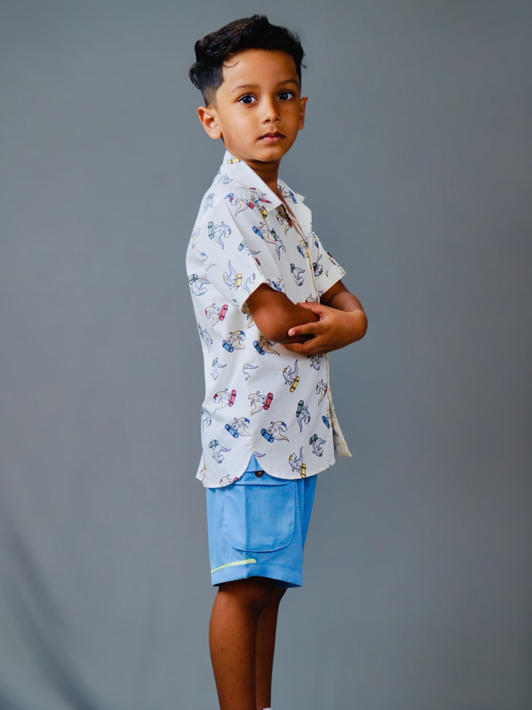 Boy wearing cotton white shirt with Dino print and Blue shorts