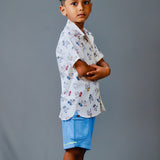 Boy wearing cotton white shirt with Dino print and Blue shorts