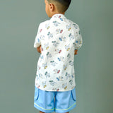 Boy wearing cotton white shirt with Dino print and Blue shorts