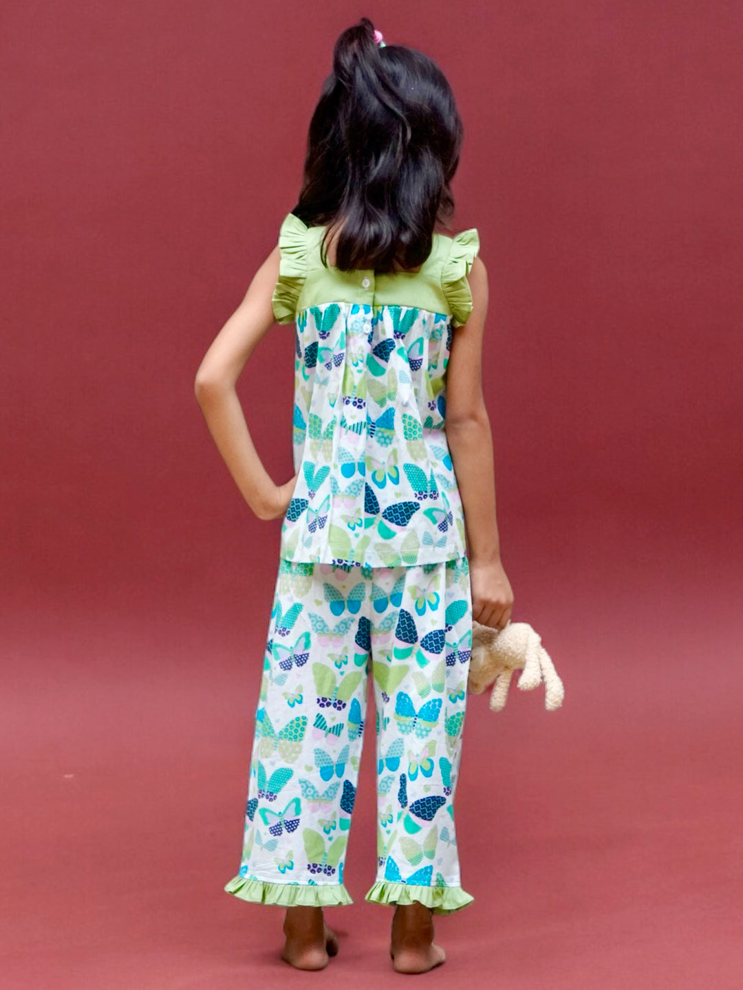 A girl wearing butterfly printed cotton suit with capri