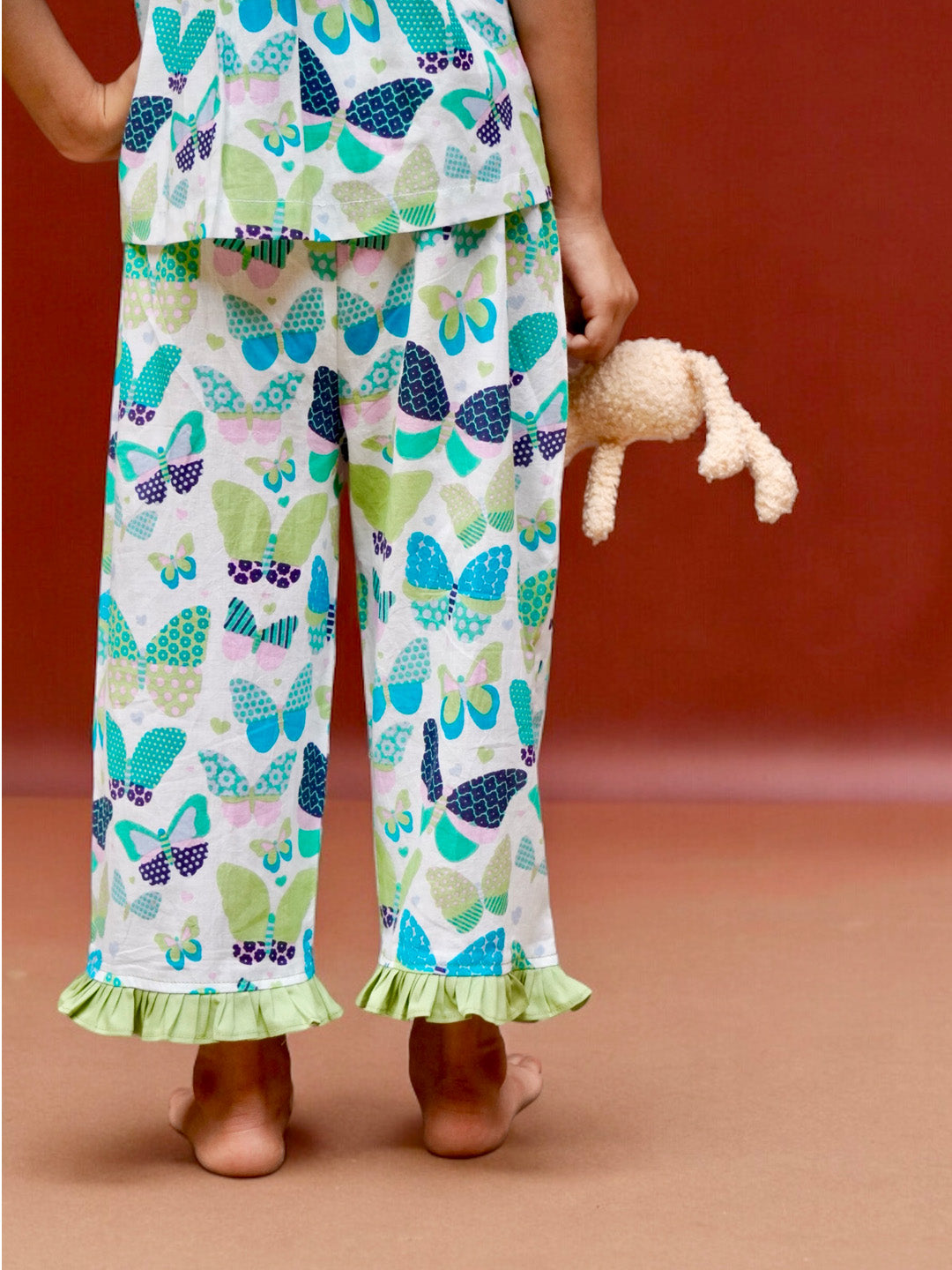 A girl wearing butterfly printed cotton suit with capri