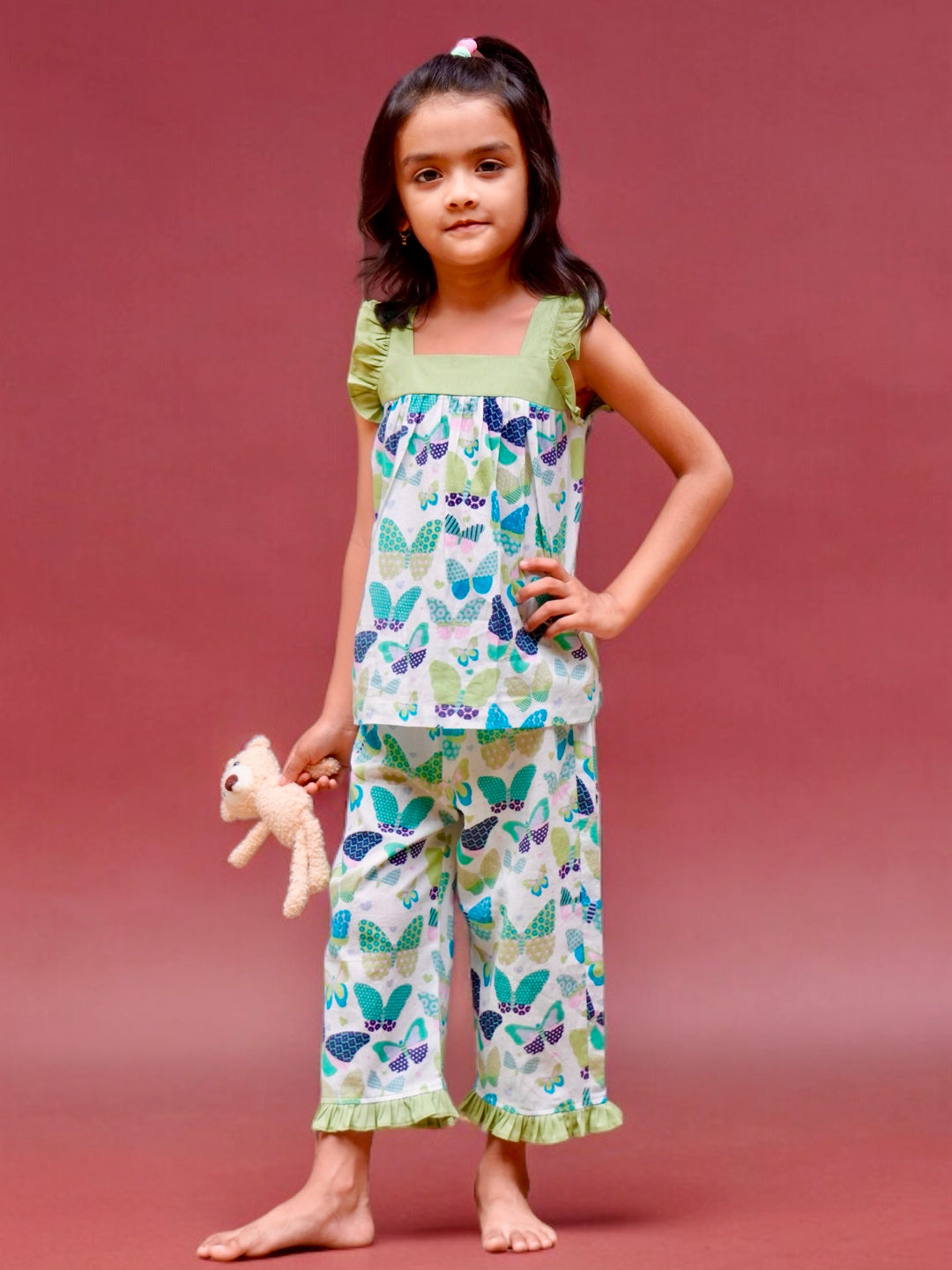 A girl wearing butterfly printed cotton suit with capri