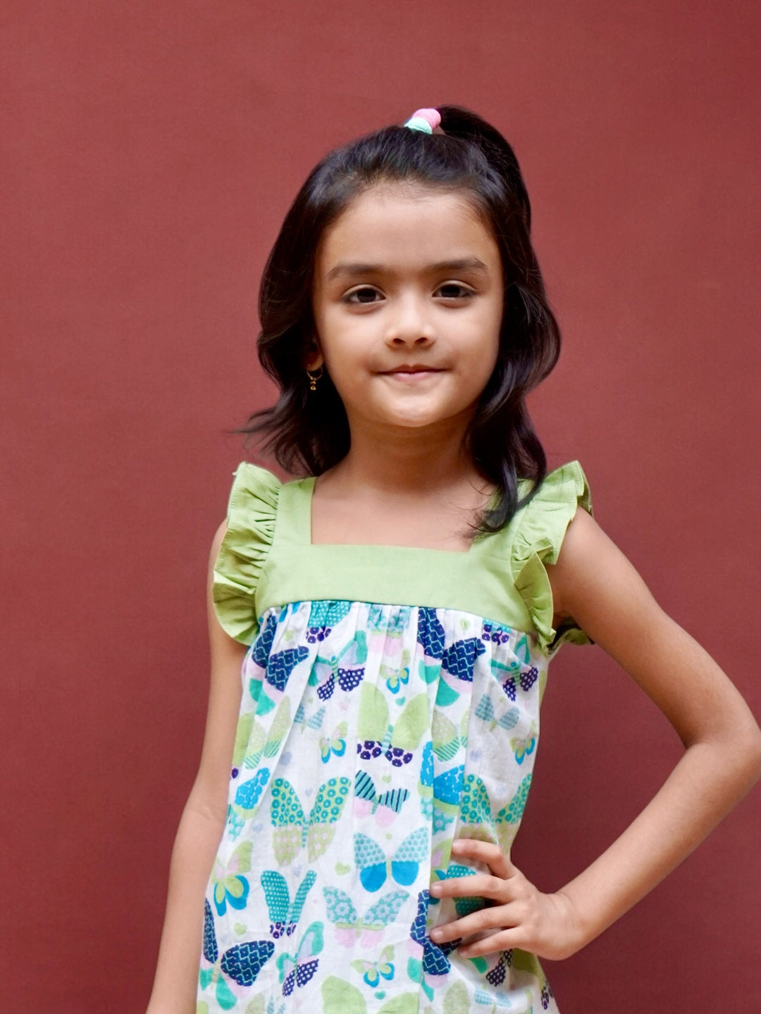 A girl wearing butterfly printed cotton suit with capri