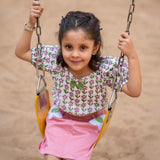 A girl wearing Block print cotton crop top and peach skirt with flowers